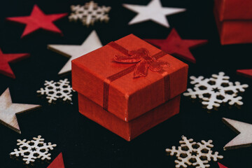 handmade red gift box and snowflakes isolated on black background, beautiful christmas decoration