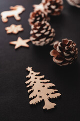wooden winter elements, pine cone isolated on black background, beautiful christmas decoration