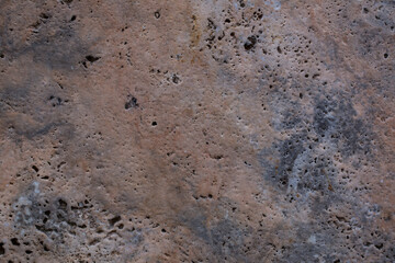 Wall of travertine with stone layers of different colors. Close up architecture macro photography. Creative wallpaper photography.