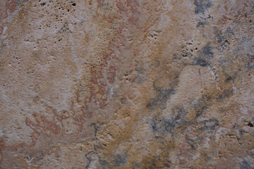 Wall of travertine with stone layers of different colors. Close up architecture macro photography. Creative wallpaper photography.
