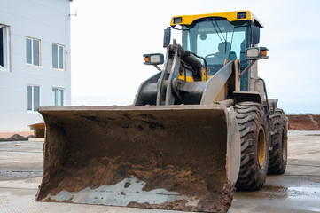 Front-end loader at a construction site. Big loader close-up.