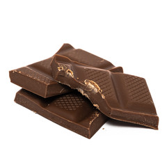 Pieces of dark chocolate isolated on white background with copyspace for text.