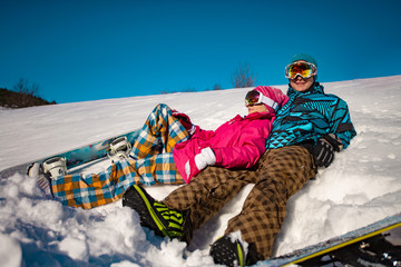 A pair of snowboarders on a slope