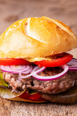 closeup of a hamburger on wood
