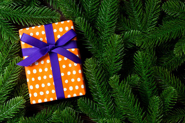 Top view of holiday gift box and fir tree branches with empty space for your design. New year ornament concept