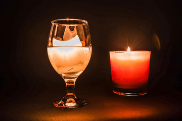 glass with a burning candle