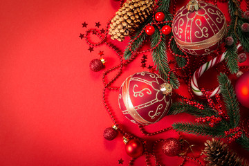 Christmas decorations on red background, top view