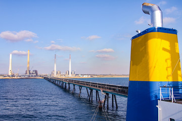 Coal ship funnel with a long industrial pier and a Coal and Gas fired power station including a...