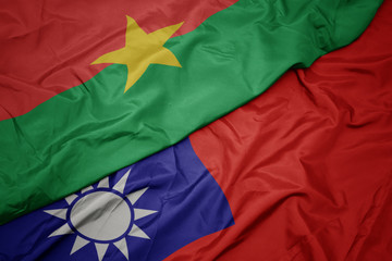 waving colorful flag of taiwan and national flag of burkina faso.