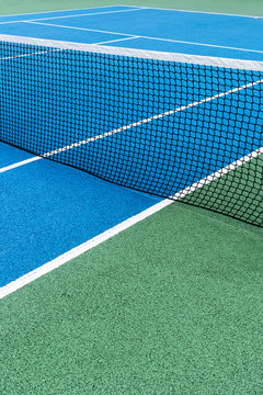 Detail of a Blue Tennis court with black net on Outdoor