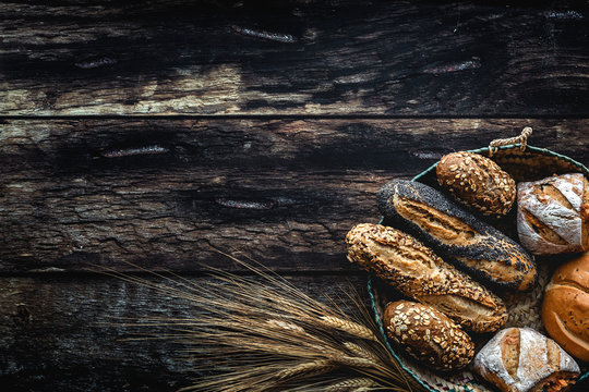 Gold Assortment Bread Homemade On Dark Wood Background, Captured From Above Top View, Flat Lay In Knolling Concept