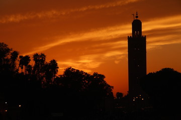 Orange sunset in the tower of the Marrakech square. Morocco