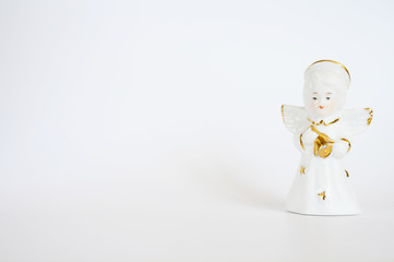 Ceramic angel figurine on a white background, Space for text