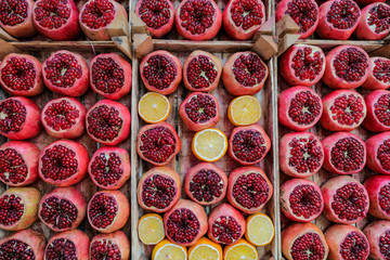 Pomegranate backgrounMany Pomegranate and a number of oranges cut in half .