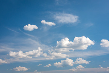 Fototapeta premium Cumulus clouds slowly moving in the blue summer sky