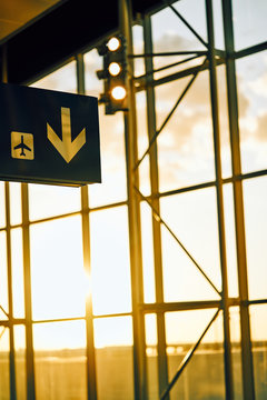 Black sign with yellow arrow pointing direction and airplane location in airport Texas