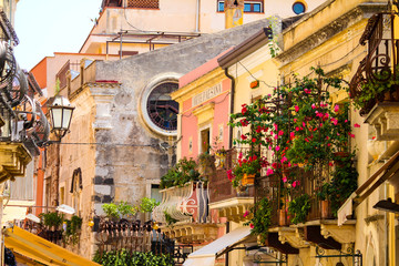 typical street with old palaces and baroque balconies in Taormina in Sicily, Italy