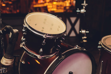 Plakat drum set in dramatic light on a black background.