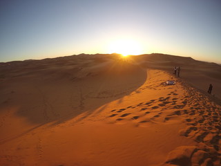 Fototapeta na wymiar Beautiful sunrise in the desert of Merzouga in the Erg Chebbi Dunes. Morocco