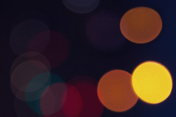 blurred colorful circle lights on the dark background, city light, abstract composition.