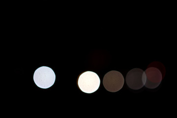 blurred colorful circle lights on the dark background, city light, abstract composition.