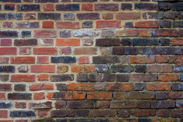 Historic old brick wall from the 12th century partially restored