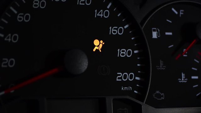 Airbags. light icon on car dashboard.Black background.