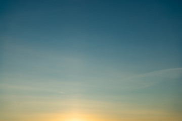 Beautiful clear, morning sky at sunrise, natural background. Soft gradient from orange to blue.