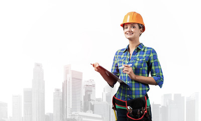 Young engineer in hardhat standing in front