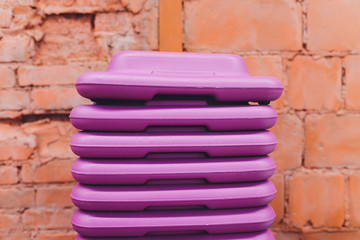 Receding row of weights lined up in a gym waiting for clients with focus to the third and fourth...