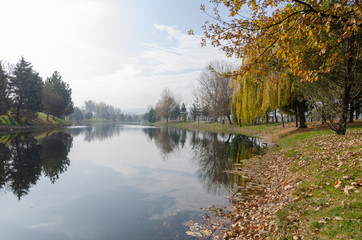 The woman is walking by the river