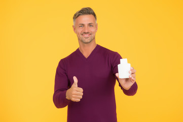 Body care. Presenting product. Mature man pointing at bottle. Favorite lotion after shaving. Worth to try. Cosmetics for men. Beauty product. Handsome well groomed healthy guy recommend product