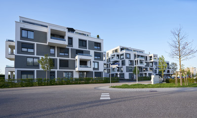 Fototapeta na wymiar Pforzheim, Germany - April 21, 2019: Modern cube-shaped apartment building with exposed balconies in a modern European area