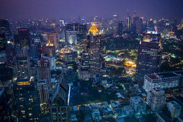 Fototapeta na wymiar The enlightened skyscrapers of Bangkok skyline during night in Thailand