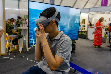 Young man using Virtual Reality glasses.