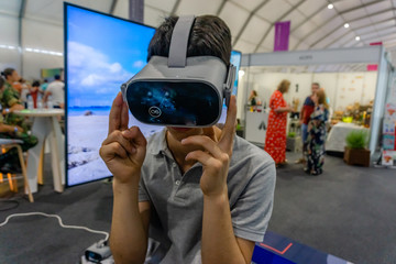 Young man using Virtual Reality glasses.