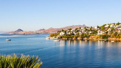 Aegean coast with marvelous blue water, rich nature, islands, mountains and small white houses