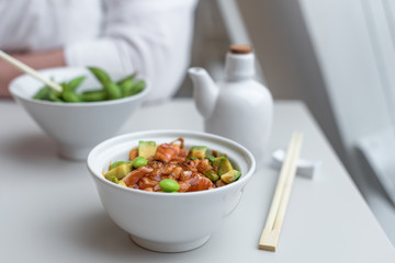 Chirashi Sushi Rice Bowl. Japanese Appetizer with Burnt Salmon, Edamame Soybeans, Avocado and Rice