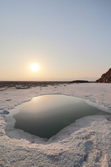 Salt water pool during sunset in the Danakil depression