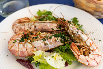 fried big shrimps with lettuce on white plate