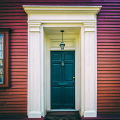 Black door on red historic home