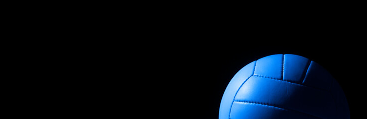 Blue leather volleyball detail on black background