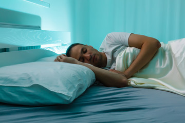 Serene man sleeping in his bedroom