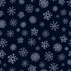 Seamless background of hand drawn snowflakes
