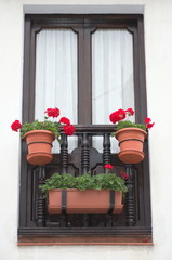 A flowery balcony in a typical house of Cantabria, Spain