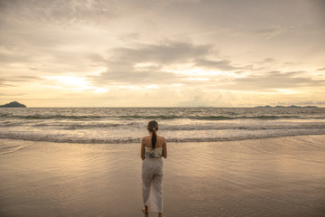 Woman near the ocean.Walking on the beach.
