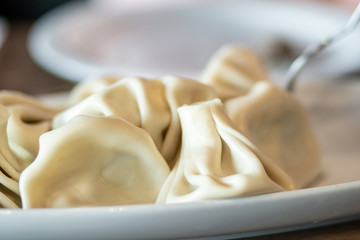 Georgian dumplings Khinkali with meat on white plate