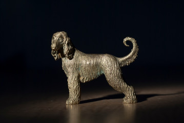 Afghan hound dog in metal, golden colour standing long haired