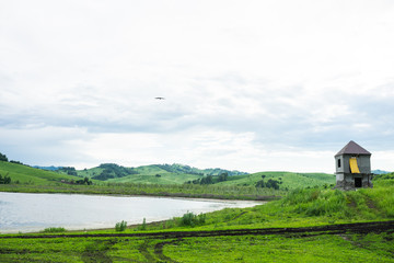 Russian green hills and meadows in Altai. Aya Lake for tourists. The sun and sunset of the day. Summer and grass. Nature travel