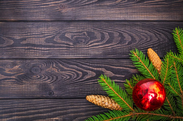 Beautiful Christmas border of spruce and toys on a dark wooden vintage background